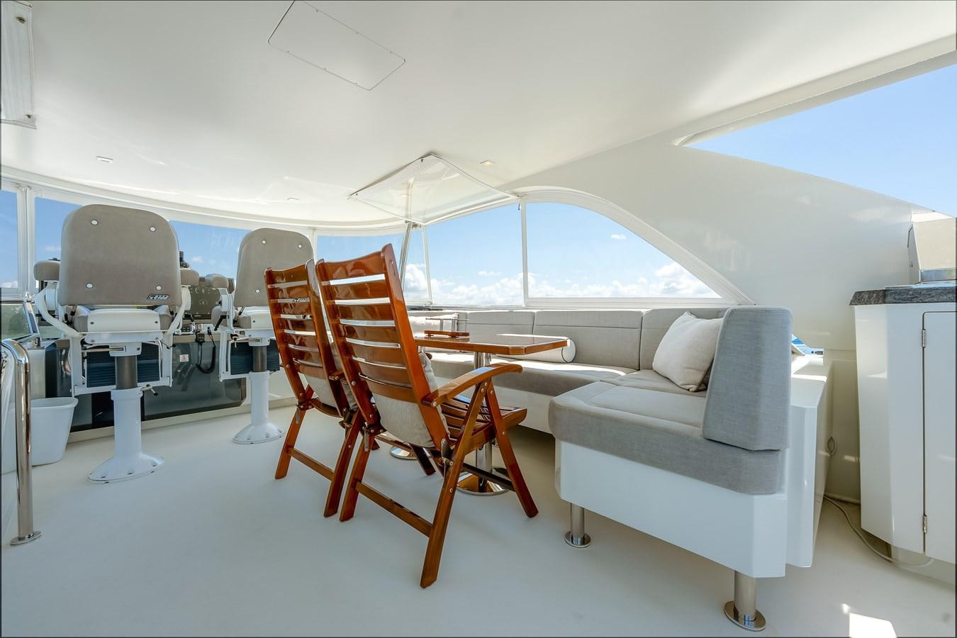a room with a couch and a table and chairs aboard 2018 OCEAN ALEXANDER 70E TIRESUM Yacht for Sale