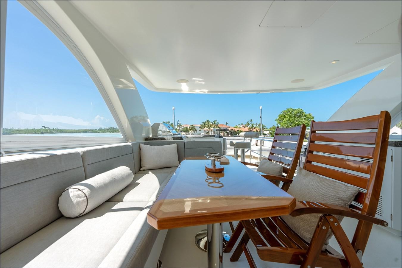 a table and chairs on a boat aboard 2018 OCEAN ALEXANDER 70E TIRESUM Yacht for Sale