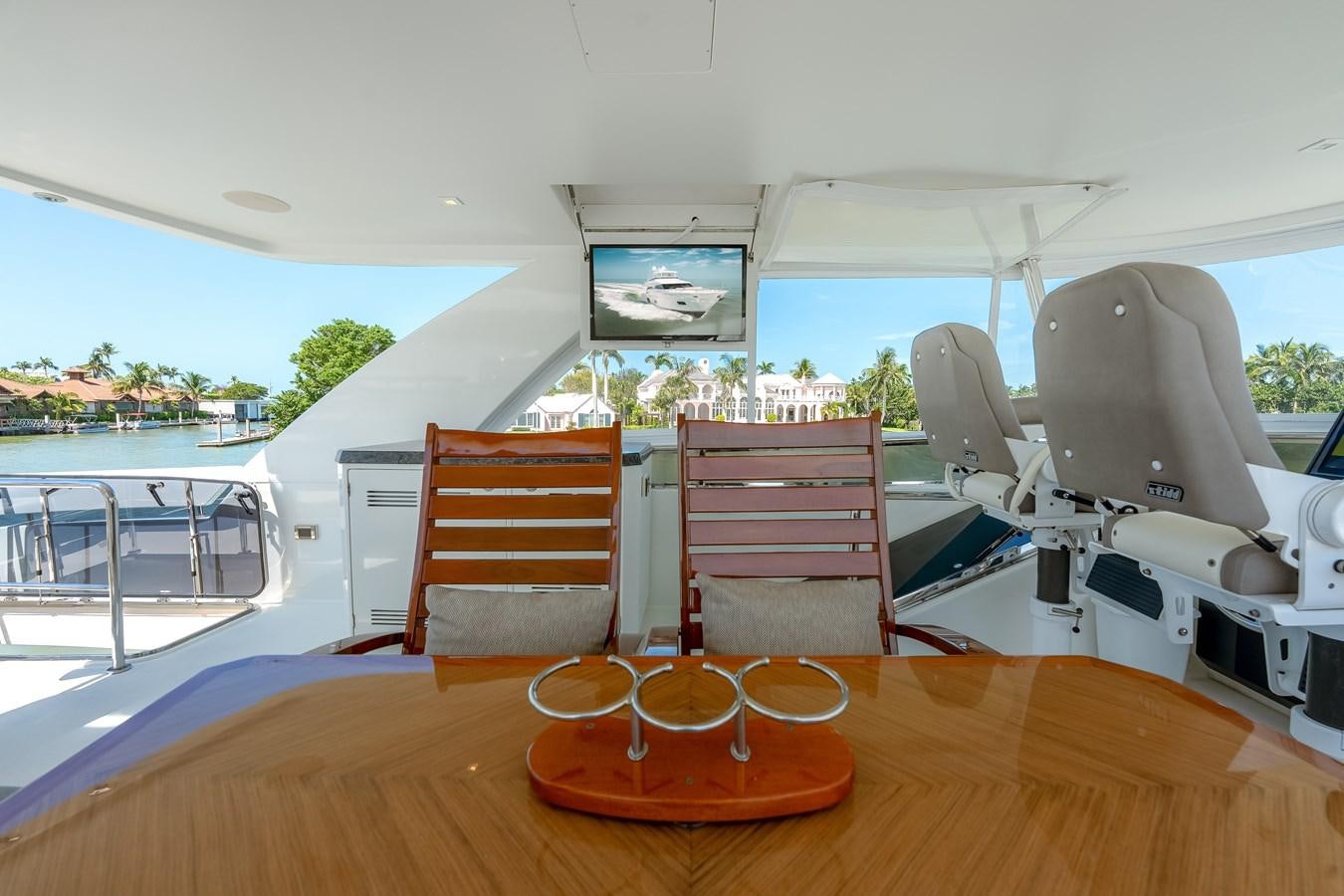 a table with chairs on it aboard 2018 OCEAN ALEXANDER 70E TIRESUM Yacht for Sale