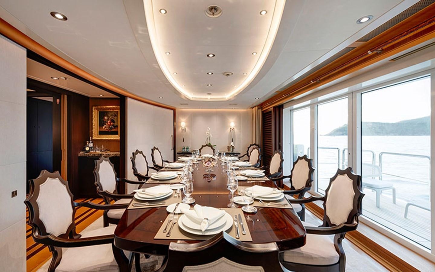 a dining room with a table set for a dinner aboard MARUN Yacht for Sale