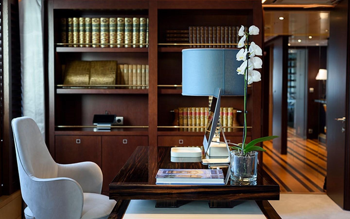 a room with a table and a chair and a bookcase aboard MARUN Yacht for Sale