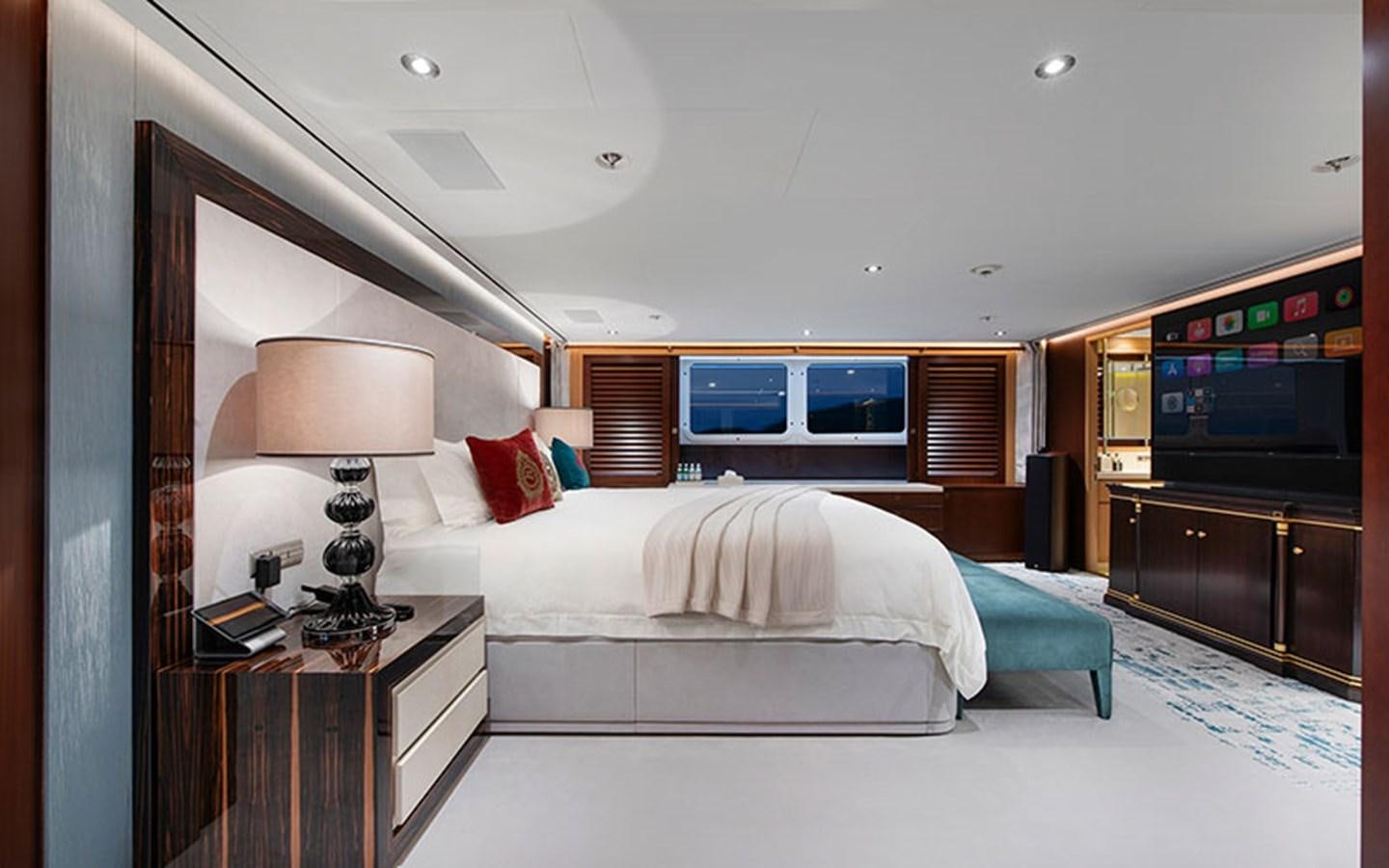 a bedroom with a bed and a television aboard MARUN Yacht for Sale