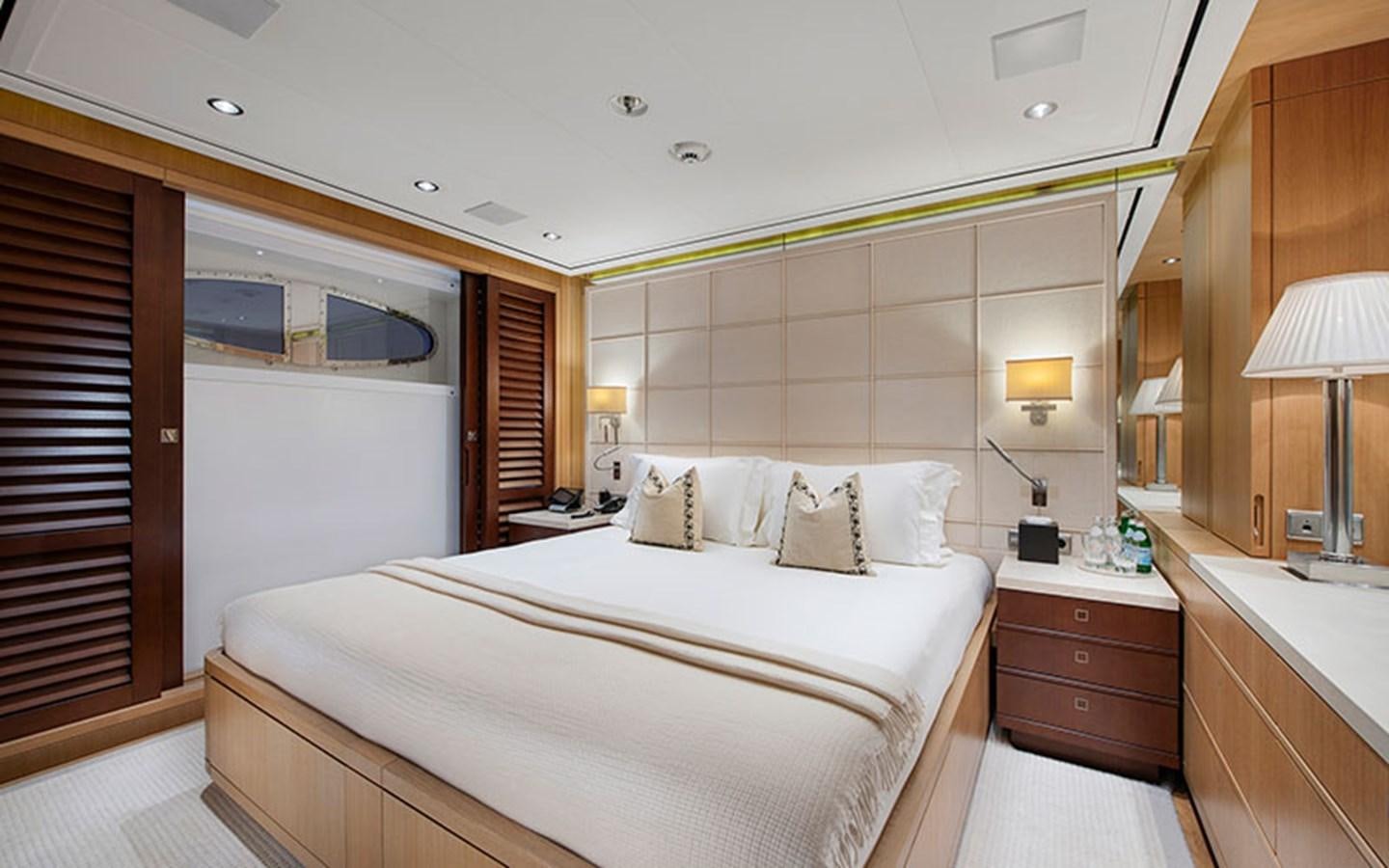 a bedroom with a bed and a window aboard MARUN Yacht for Sale