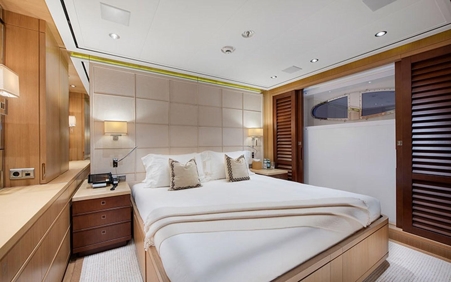 a bedroom with a bed and a window aboard MARUN Yacht for Sale