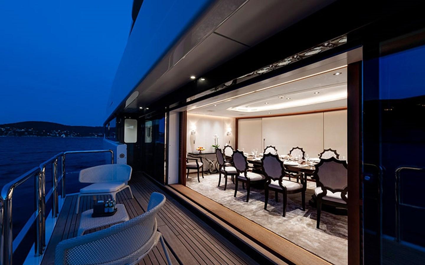 a deck with a table and chairs on it aboard MARUN Yacht for Sale