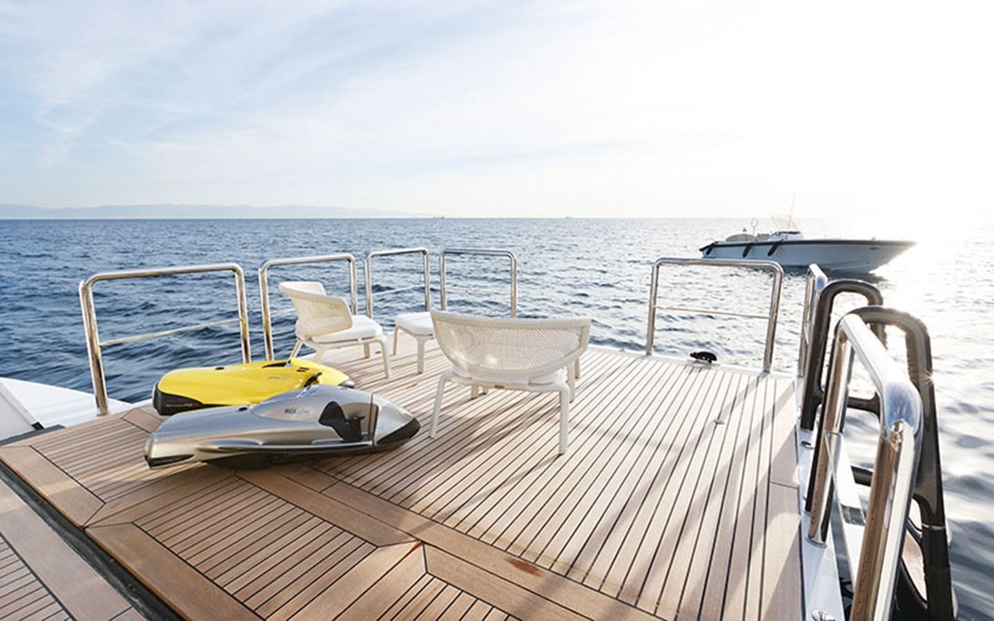 a deck with chairs and a table on it aboard MARUN Yacht for Sale