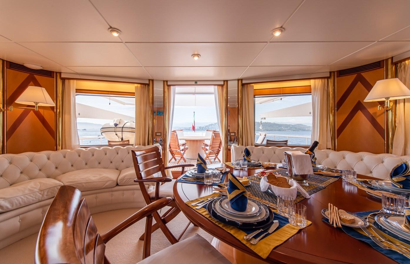 a dining table in a living room aboard SHEERGOLD Yacht for Sale