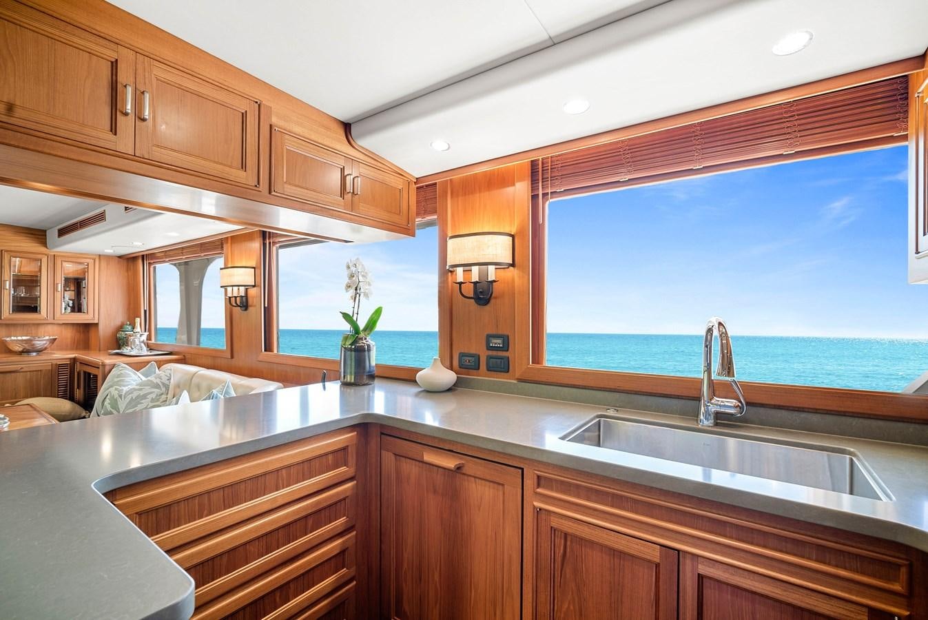 a kitchen with wooden cabinets aboard FLEMING 78 - CLASSIC FLYBRIDGE Yacht for Sale