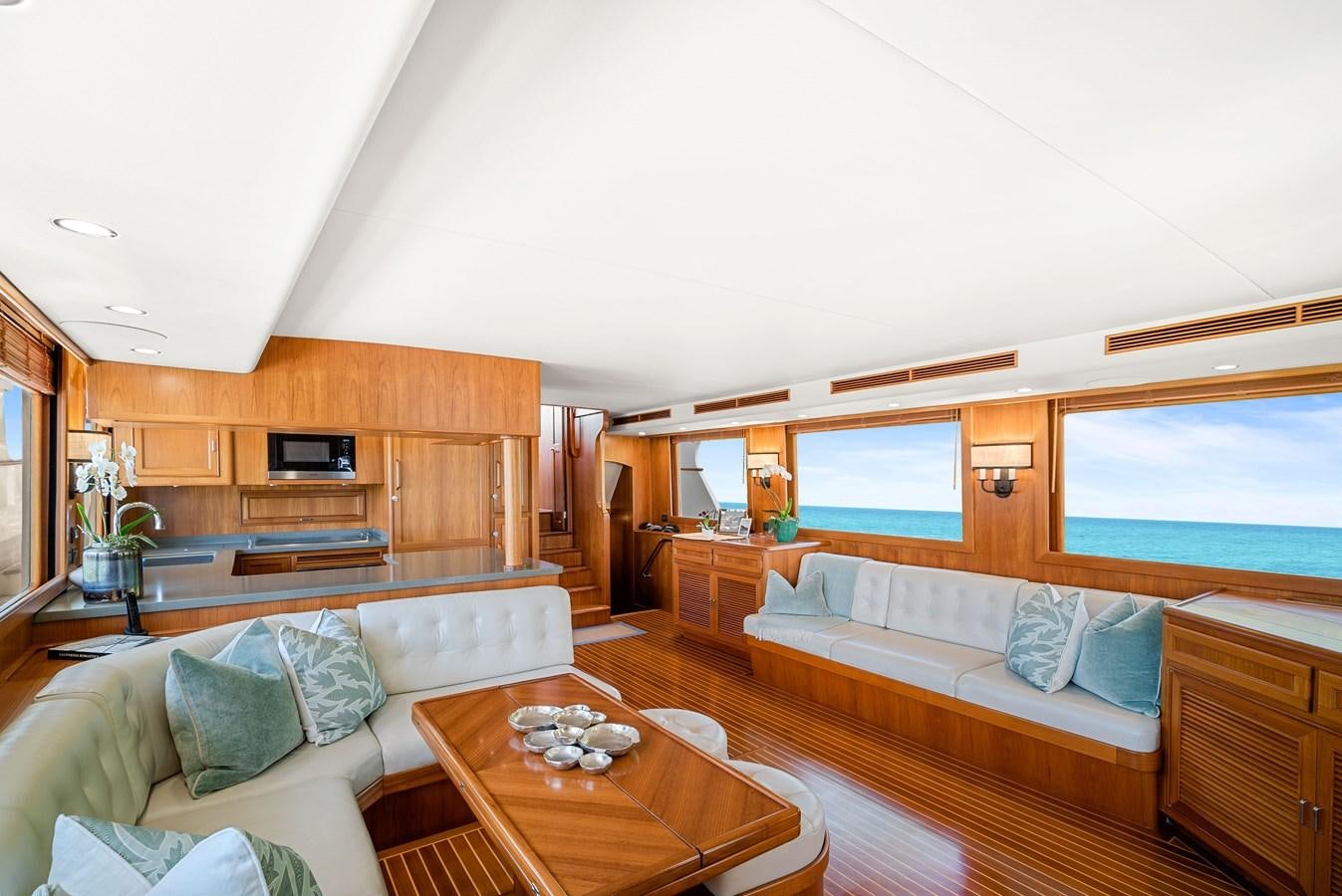 a living room with a couch and a table aboard FLEMING 78 - CLASSIC FLYBRIDGE Yacht for Sale