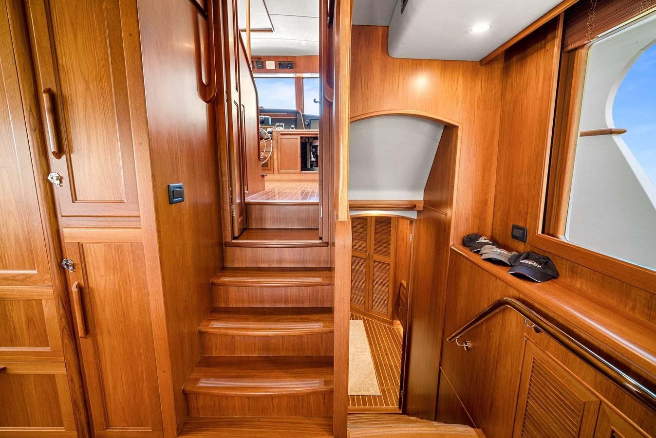 a wooden staircase in a house aboard FLEMING 78 - CLASSIC FLYBRIDGE Yacht for Sale