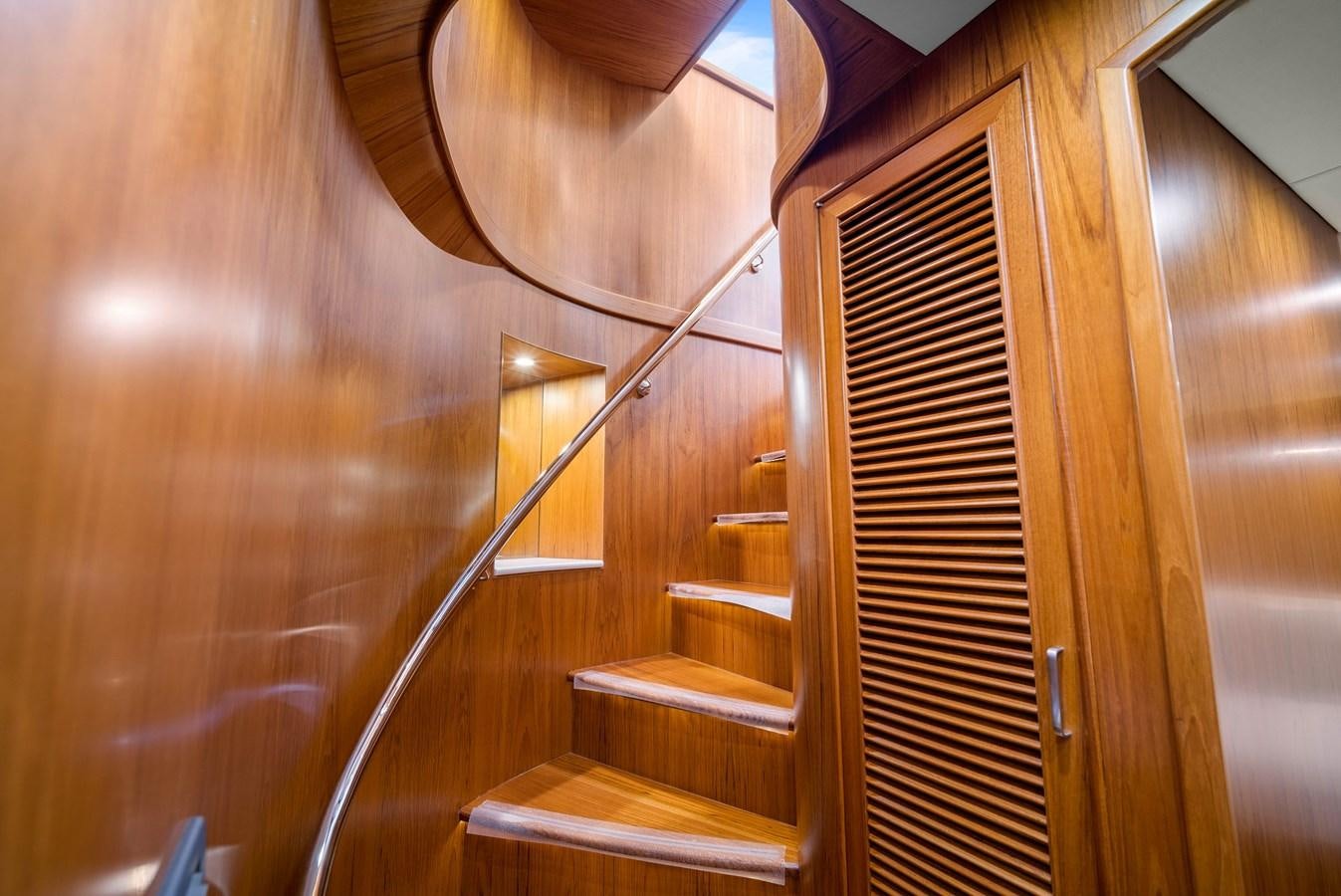 a wooden staircase with a metal railing aboard FLEMING 78 - CLASSIC FLYBRIDGE Yacht for Sale