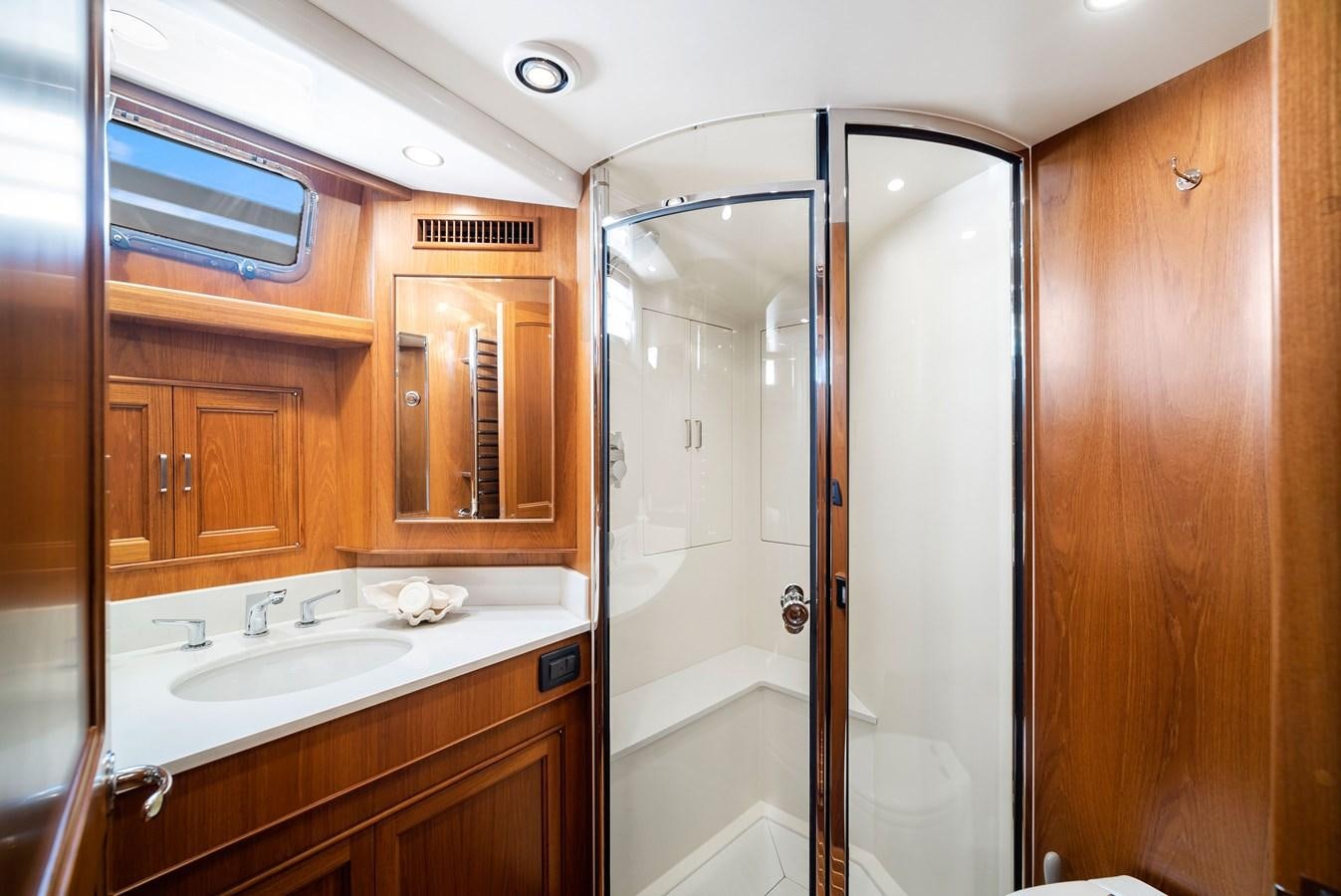 a bathroom with a shower and sink aboard FLEMING 78 - CLASSIC FLYBRIDGE Yacht for Sale