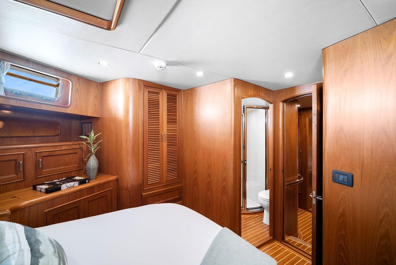 a bedroom with a bed and a closet aboard FLEMING 78 - CLASSIC FLYBRIDGE Yacht for Sale