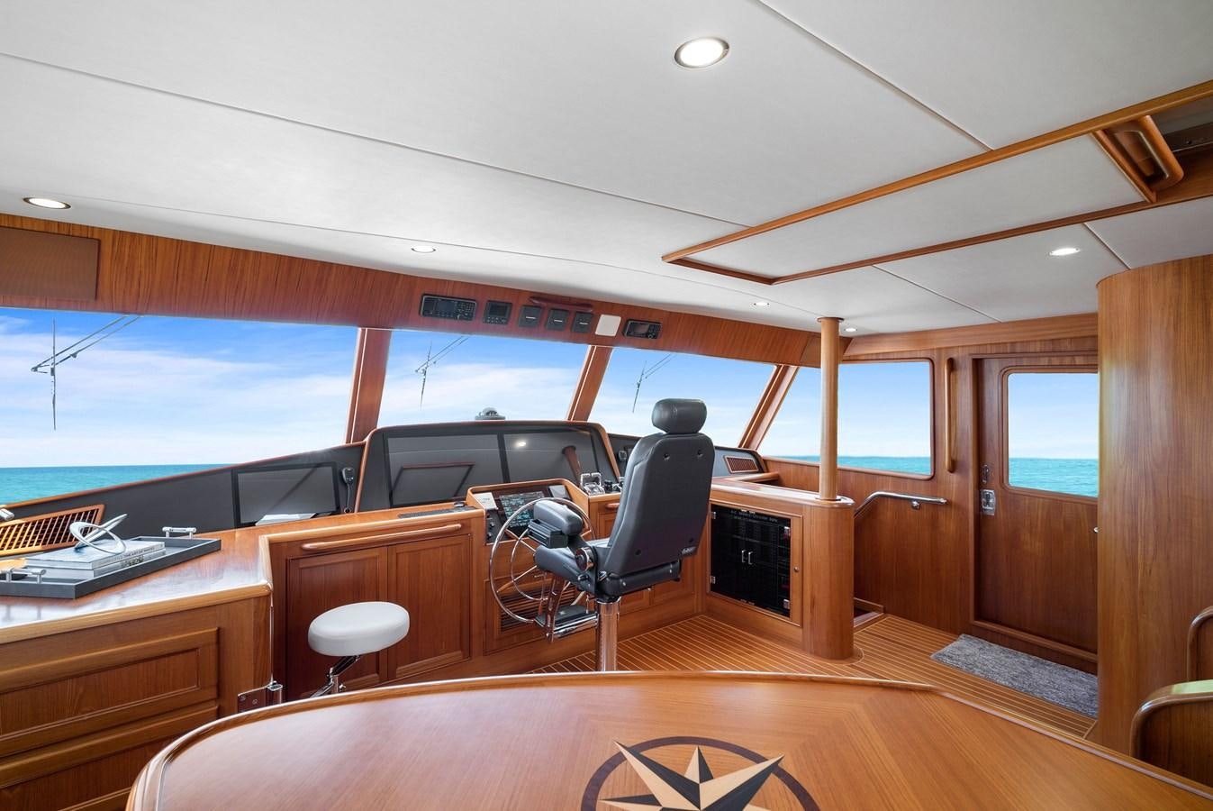 a room with a large window and a view of the water aboard FLEMING 78 - CLASSIC FLYBRIDGE Yacht for Sale