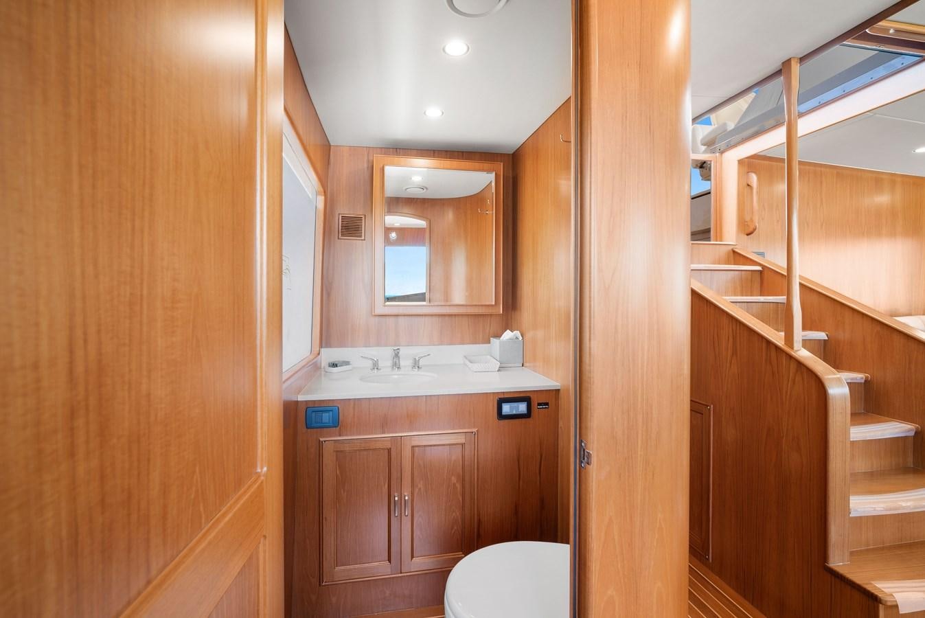 a bathroom with wooden cabinets aboard FLEMING 78 - CLASSIC FLYBRIDGE Yacht for Sale
