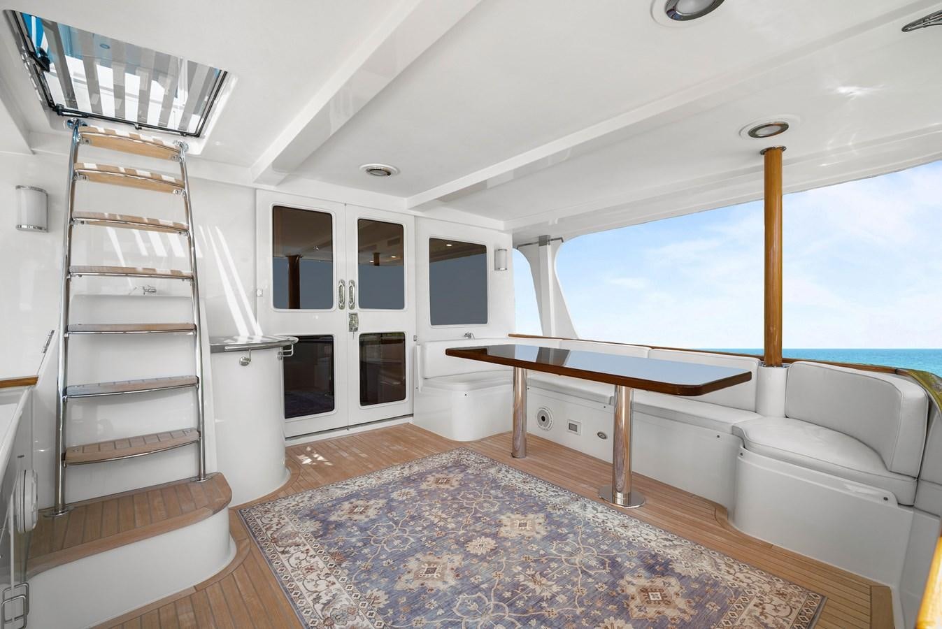 a large open space with a large window and a staircase aboard FLEMING 78 - CLASSIC FLYBRIDGE Yacht for Sale