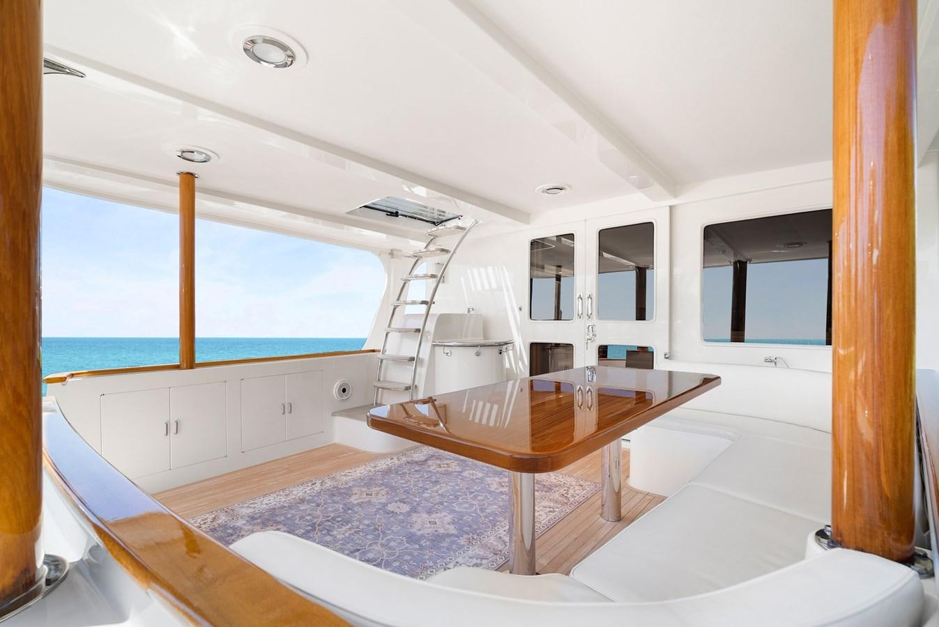 a room with a table and a window aboard FLEMING 78 - CLASSIC FLYBRIDGE Yacht for Sale