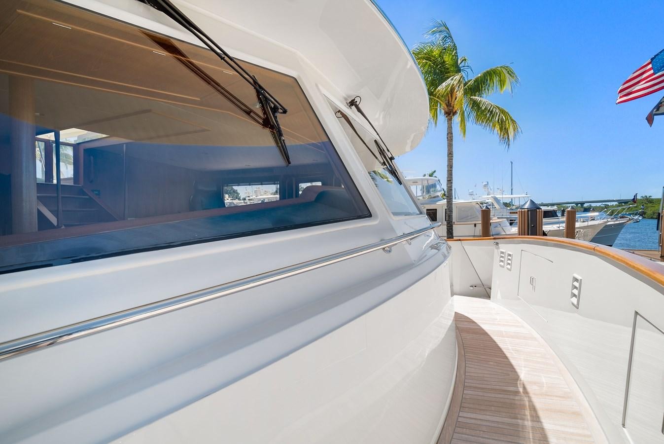 a boat with a flag on the front aboard FLEMING 78 - CLASSIC FLYBRIDGE Yacht for Sale