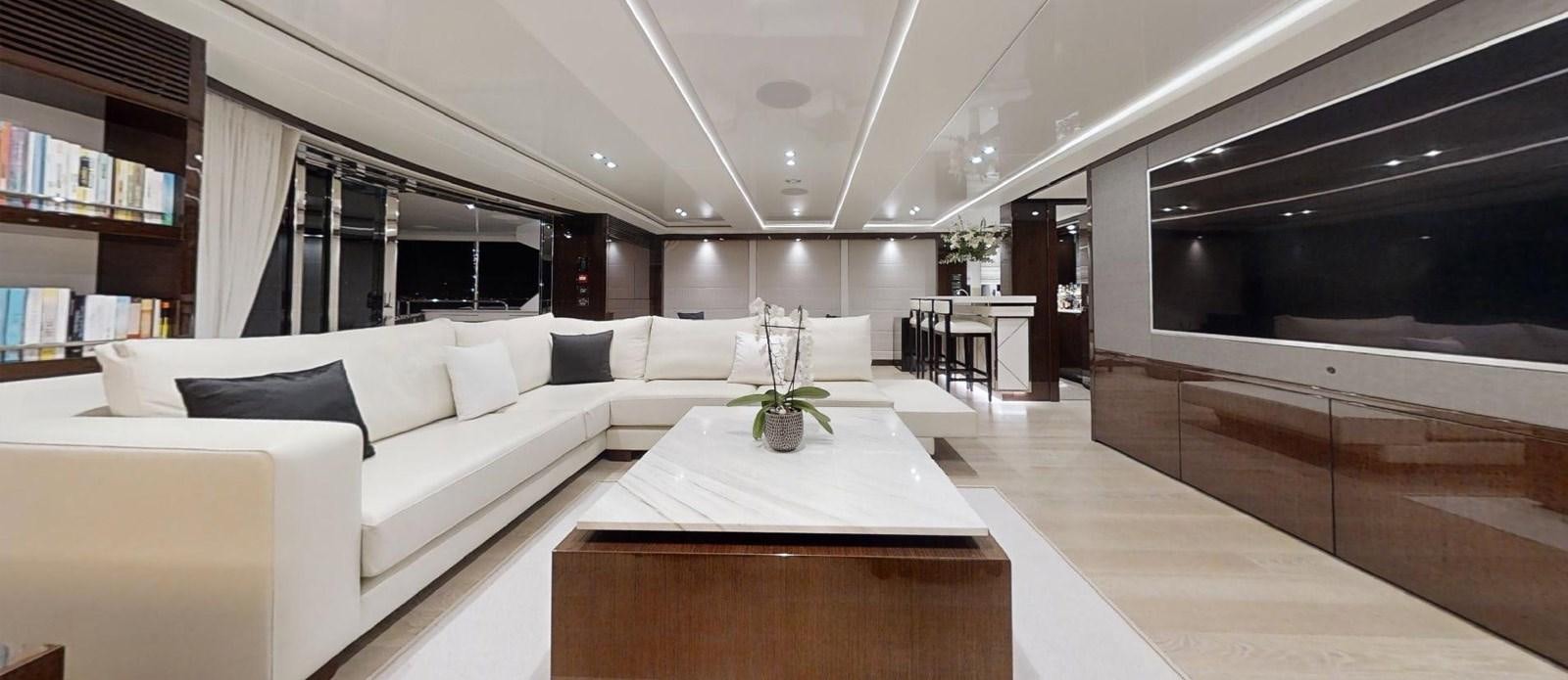 a room with a table and couch aboard ROGUE Yacht for Sale