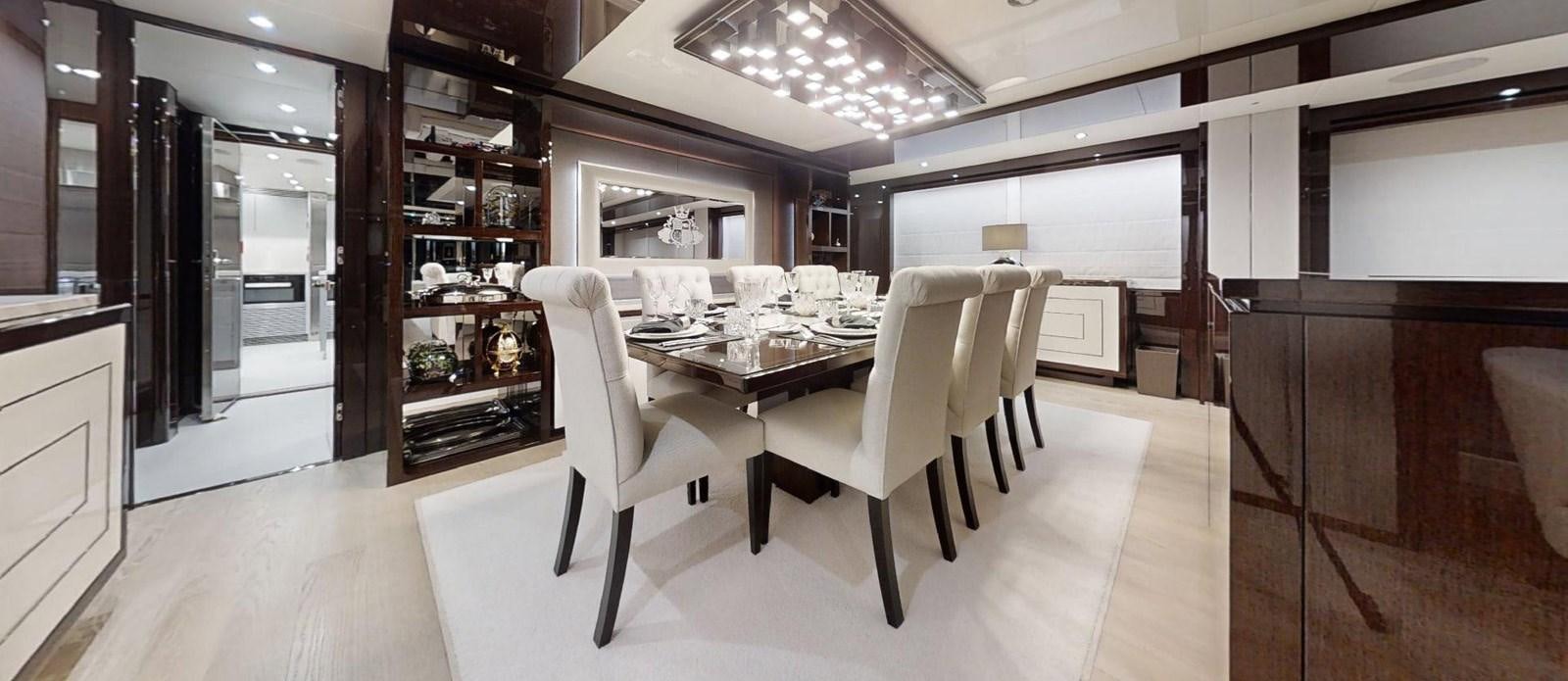 a room with a table chairs and shelves aboard ROGUE Yacht for Sale