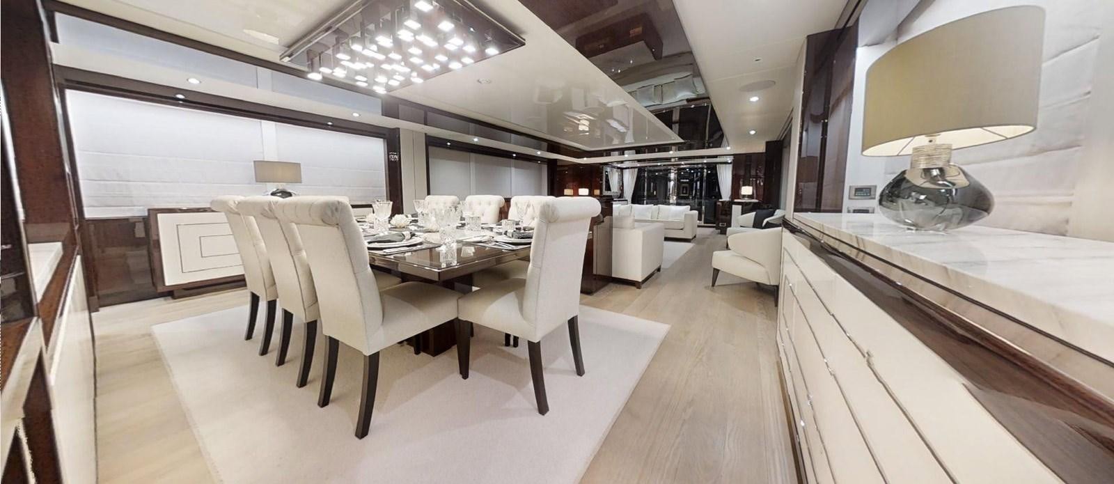 a room with tables and chairs aboard ROGUE Yacht for Sale