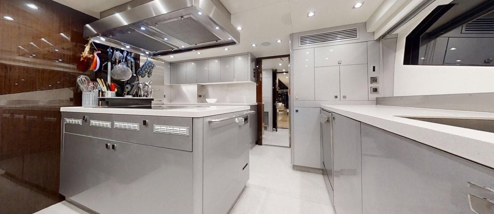 a kitchen with white cabinets aboard ROGUE Yacht for Sale
