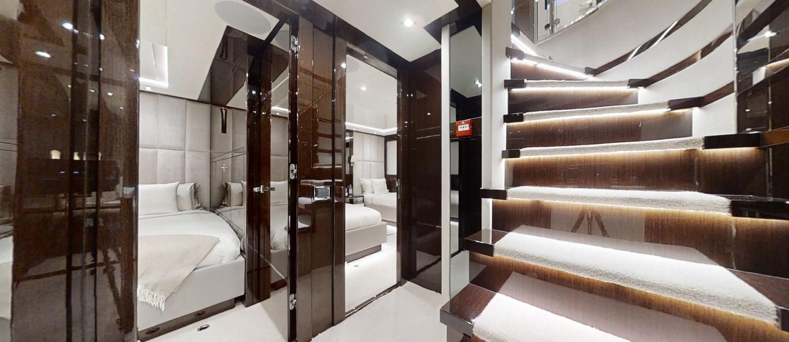 a room with a bed and a mirror aboard ROGUE Yacht for Sale