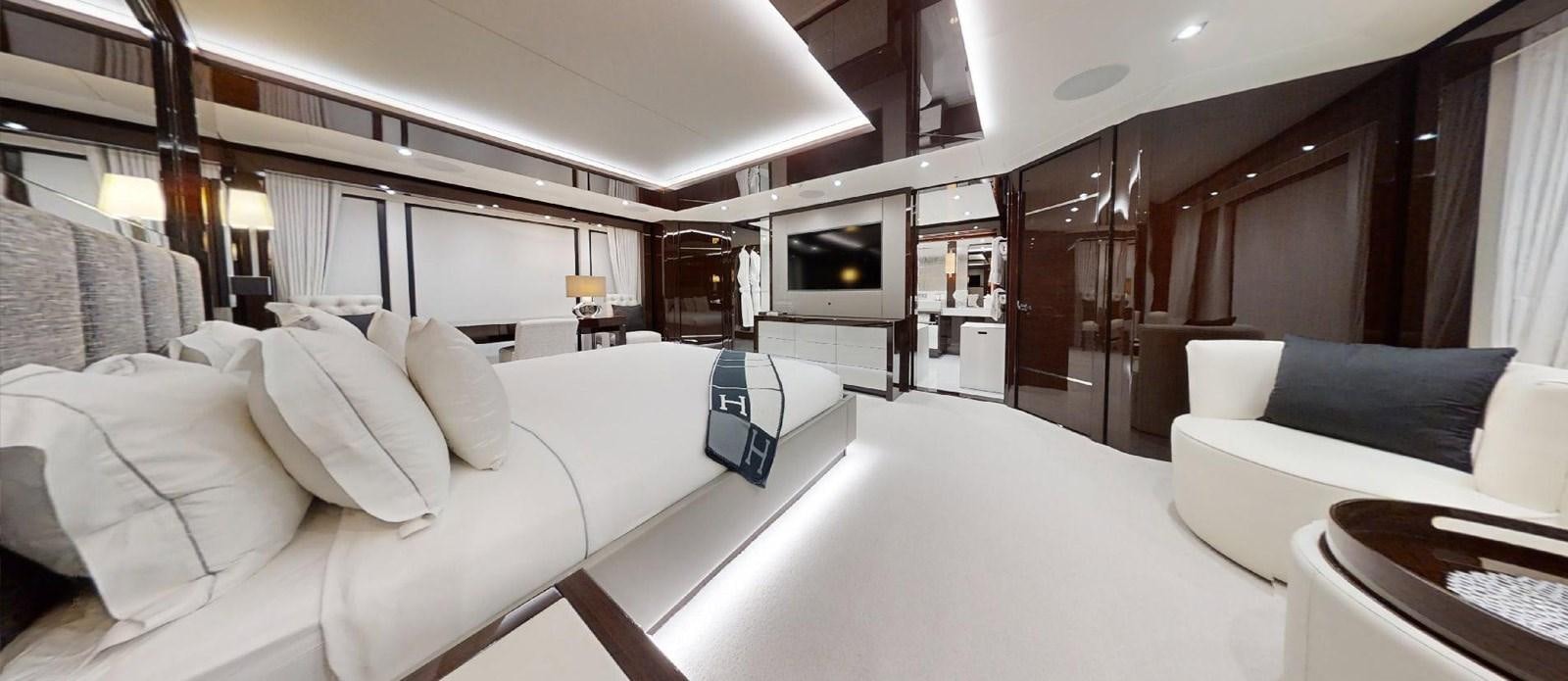 a room with a bed and a television aboard ROGUE Yacht for Sale