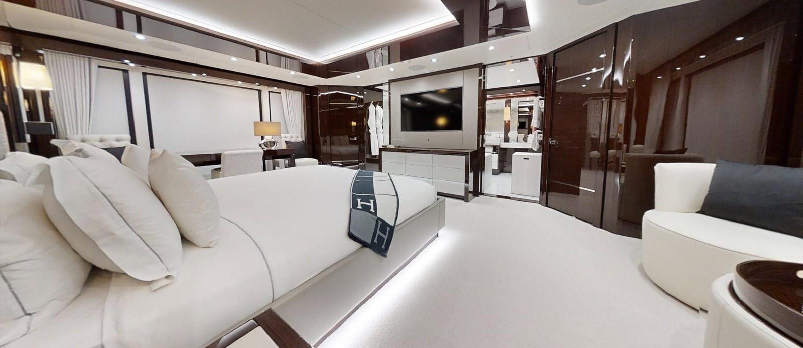a room with a bed and a television aboard ROGUE Yacht for Sale
