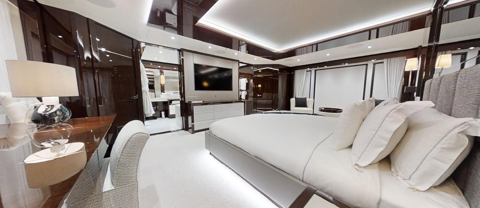 a room with a bed and a television aboard ROGUE Yacht for Sale