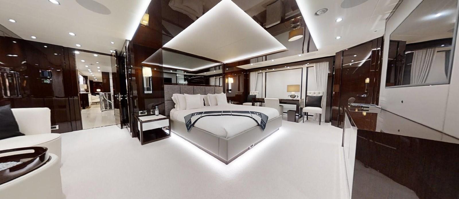 a large room with a bed and a desk aboard ROGUE Yacht for Sale