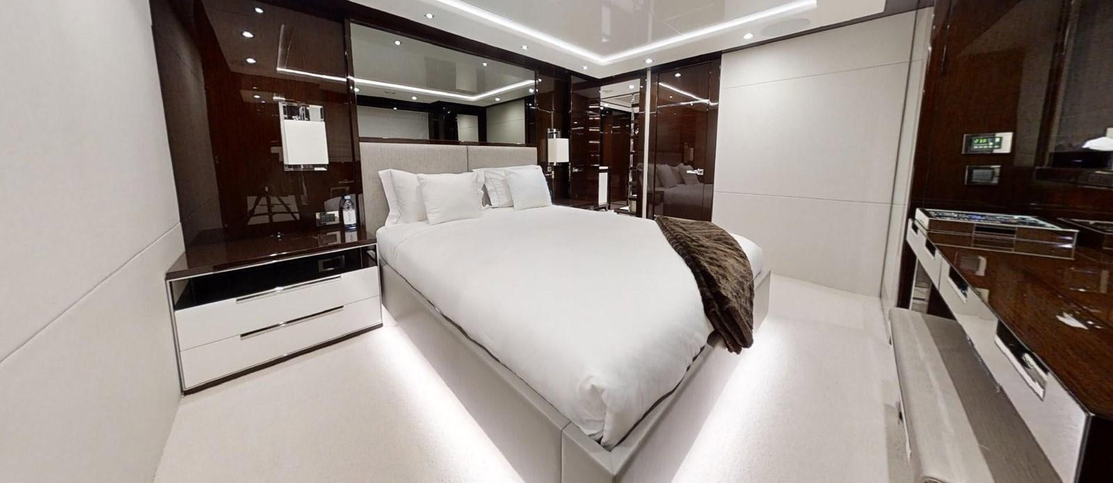 a room with a bed and desk aboard ROGUE Yacht for Sale