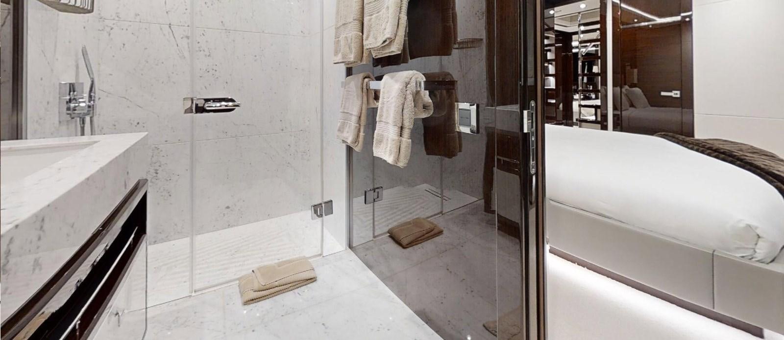 a bathroom with a tub sink and a mirror aboard ROGUE Yacht for Sale