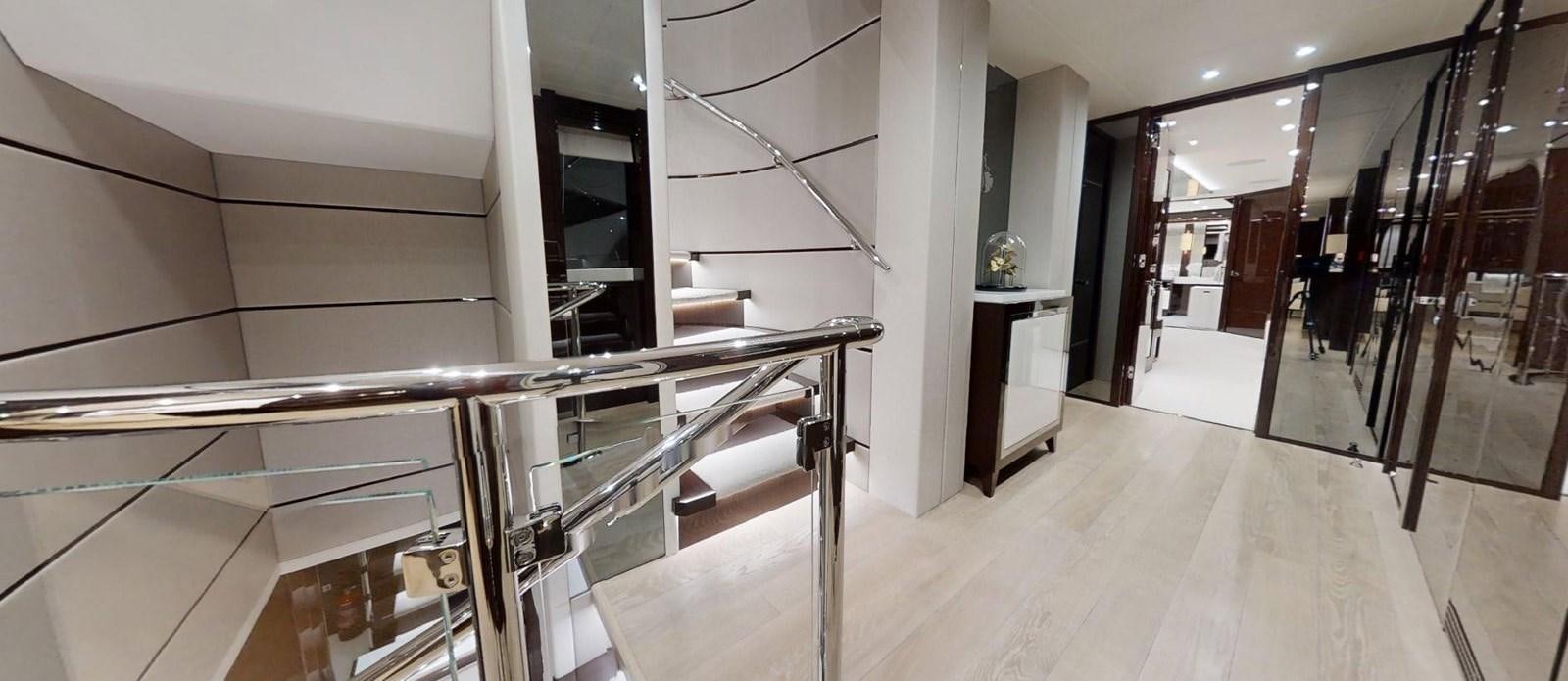 a room with a staircase and a desk aboard ROGUE Yacht for Sale