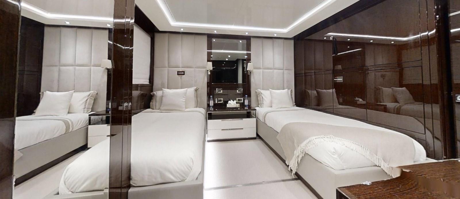 a room with a bed and a mirror aboard ROGUE Yacht for Sale