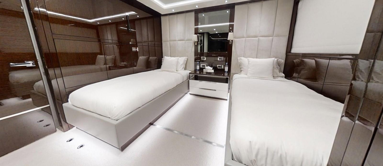 a room with a bed and a mirror aboard ROGUE Yacht for Sale