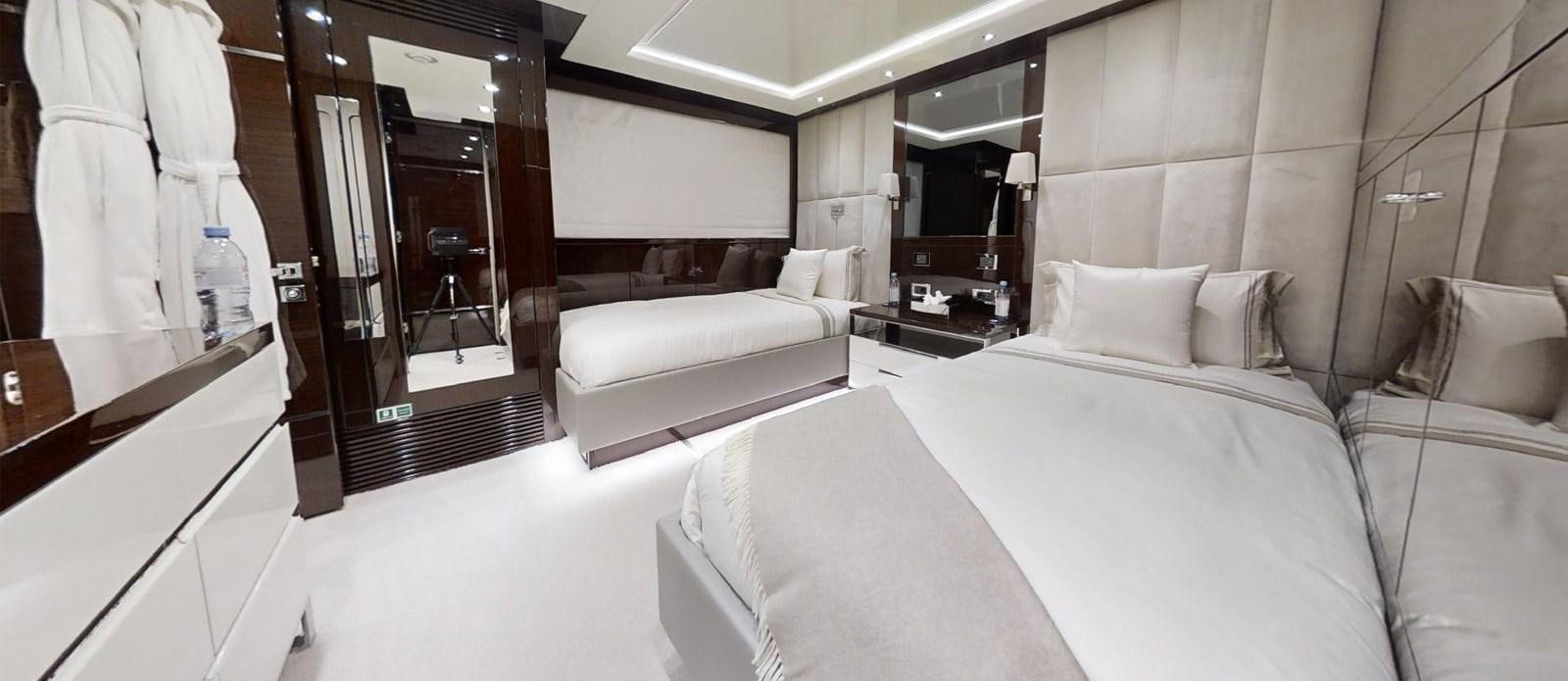 a room with a bed and a mirror aboard ROGUE Yacht for Sale