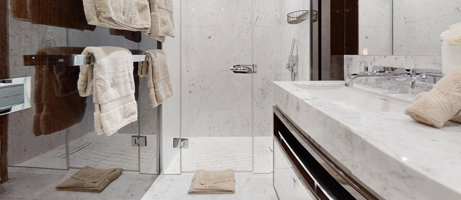 a bathroom with towels on the wall aboard ROGUE Yacht for Sale