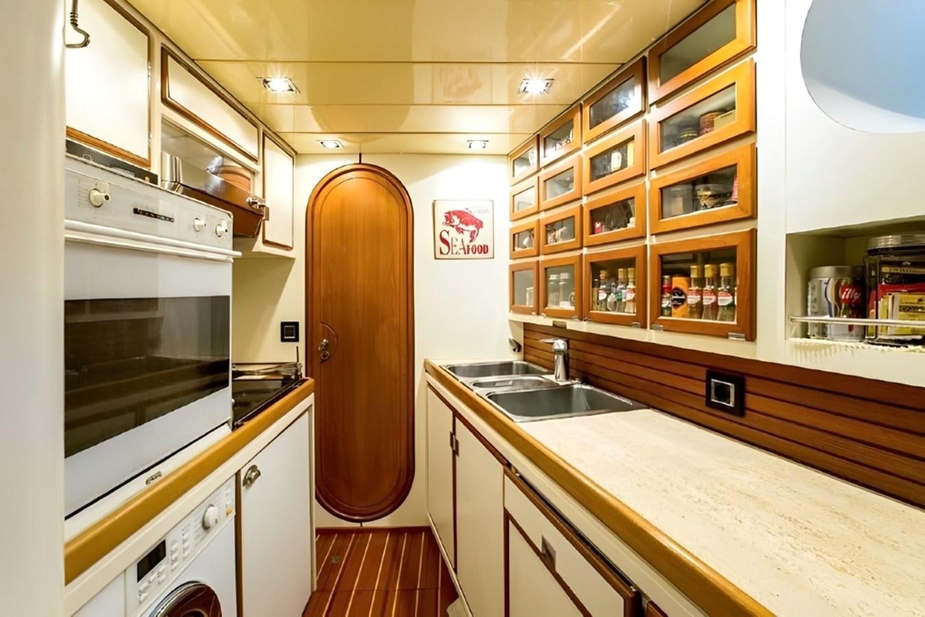 a kitchen with white cabinets aboard ELETTRA Yacht for Sale