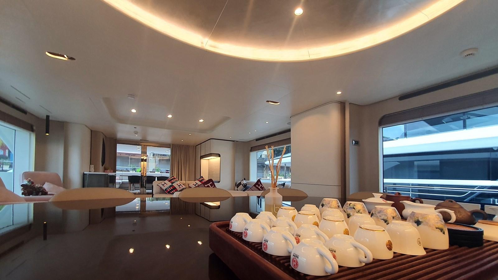 a room with a large window and a large table with chairs and a large window aboard M32 025 Yacht for Sale