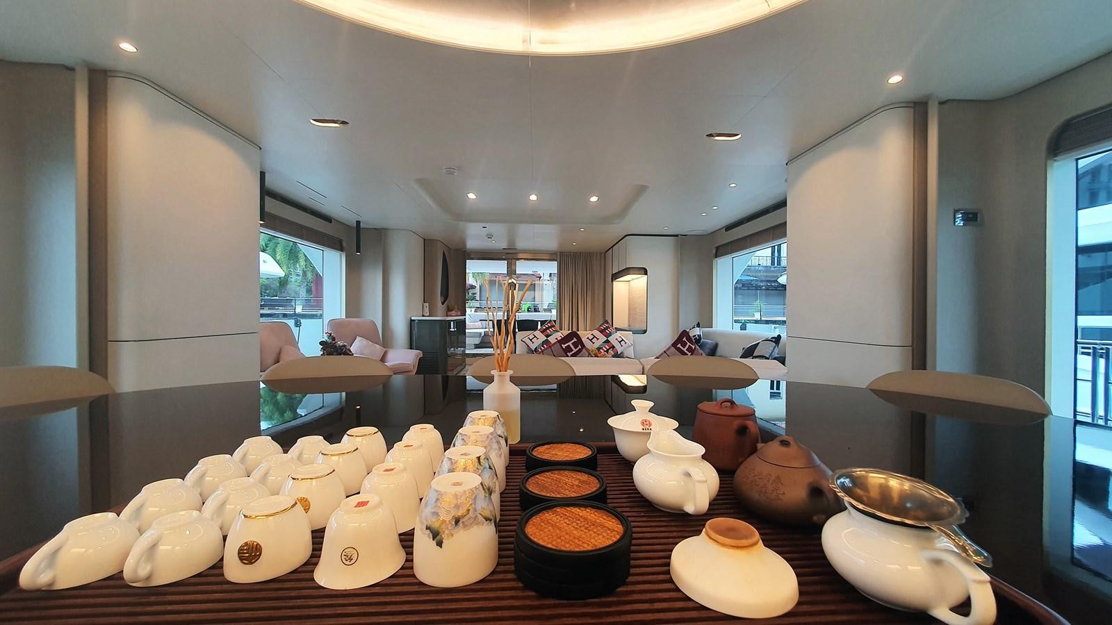 a table with many cups on it aboard M32 025 Yacht for Sale