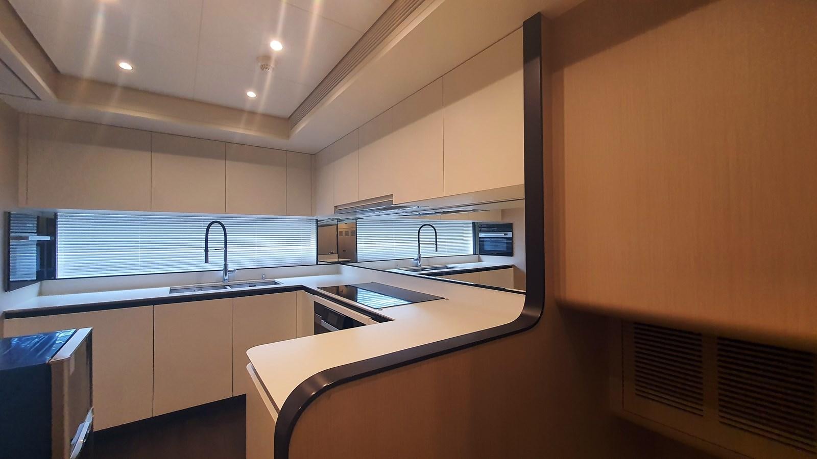 a kitchen with a sink and a microwave aboard M32 025 Yacht for Sale