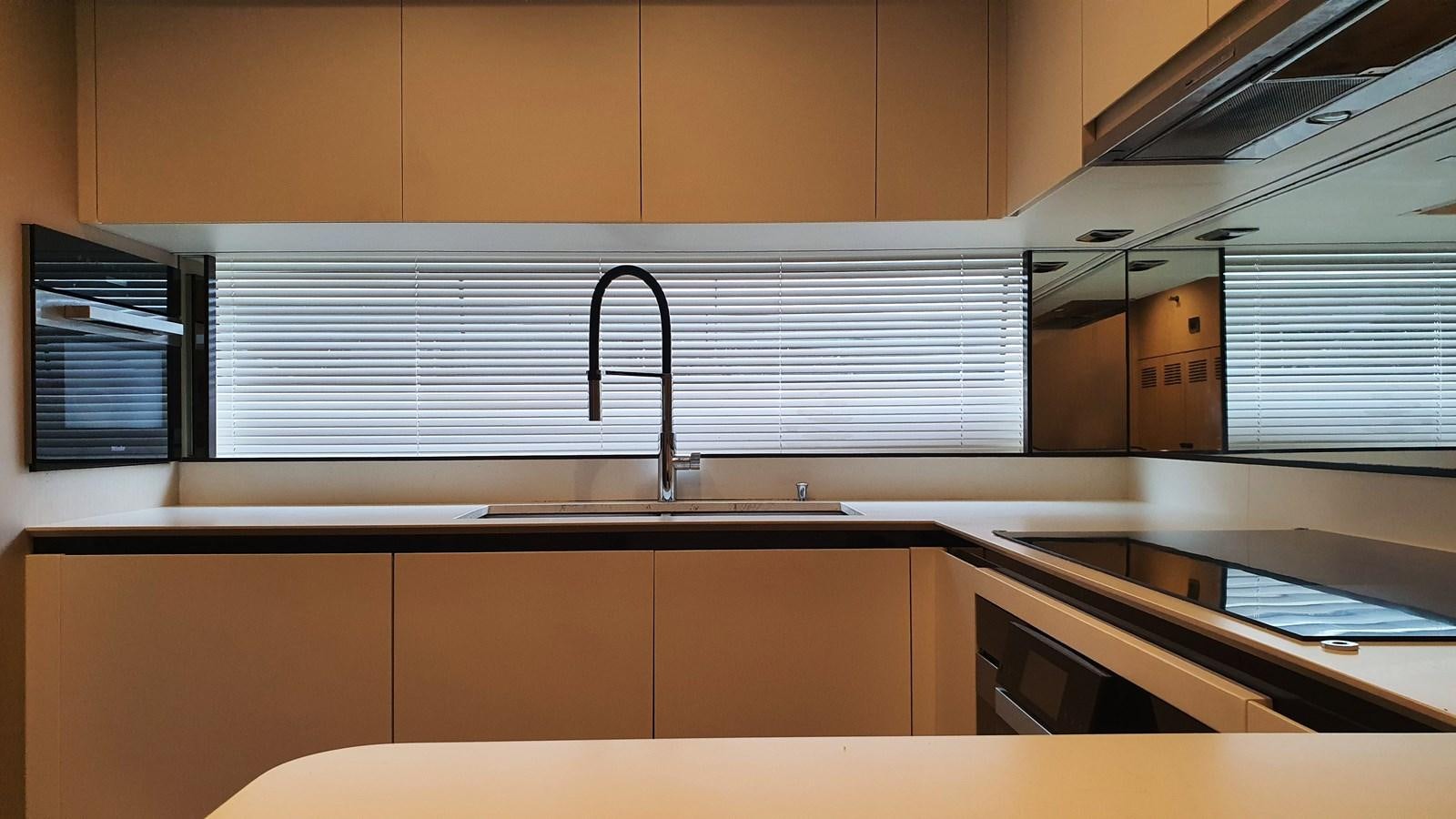 a kitchen with a sink and cabinets aboard M32 025 Yacht for Sale