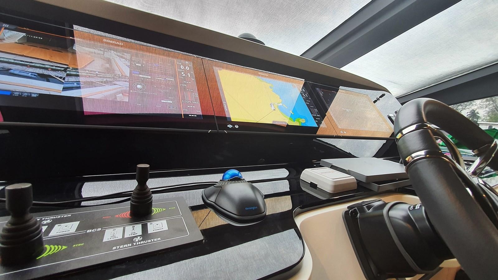 a computer monitor and mouse on a desk aboard M32 025 Yacht for Sale