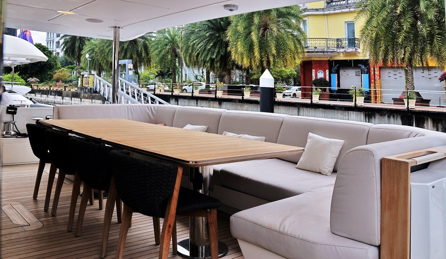 a table and chairs on a patio aboard M32 025 Yacht for Sale