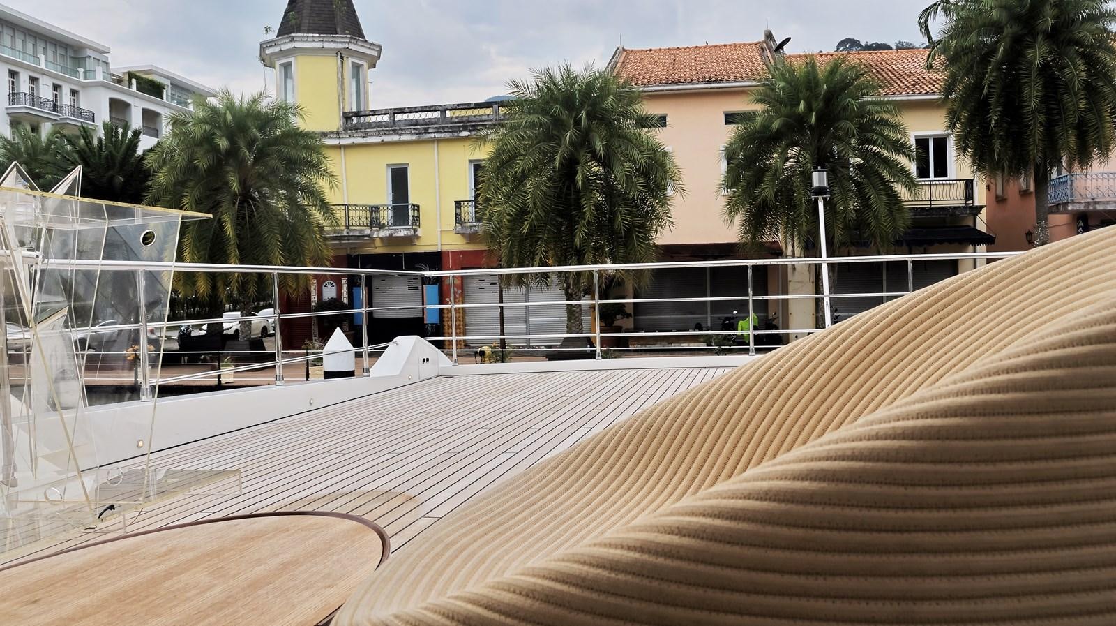 a deck with a building and trees aboard M32 025 Yacht for Sale