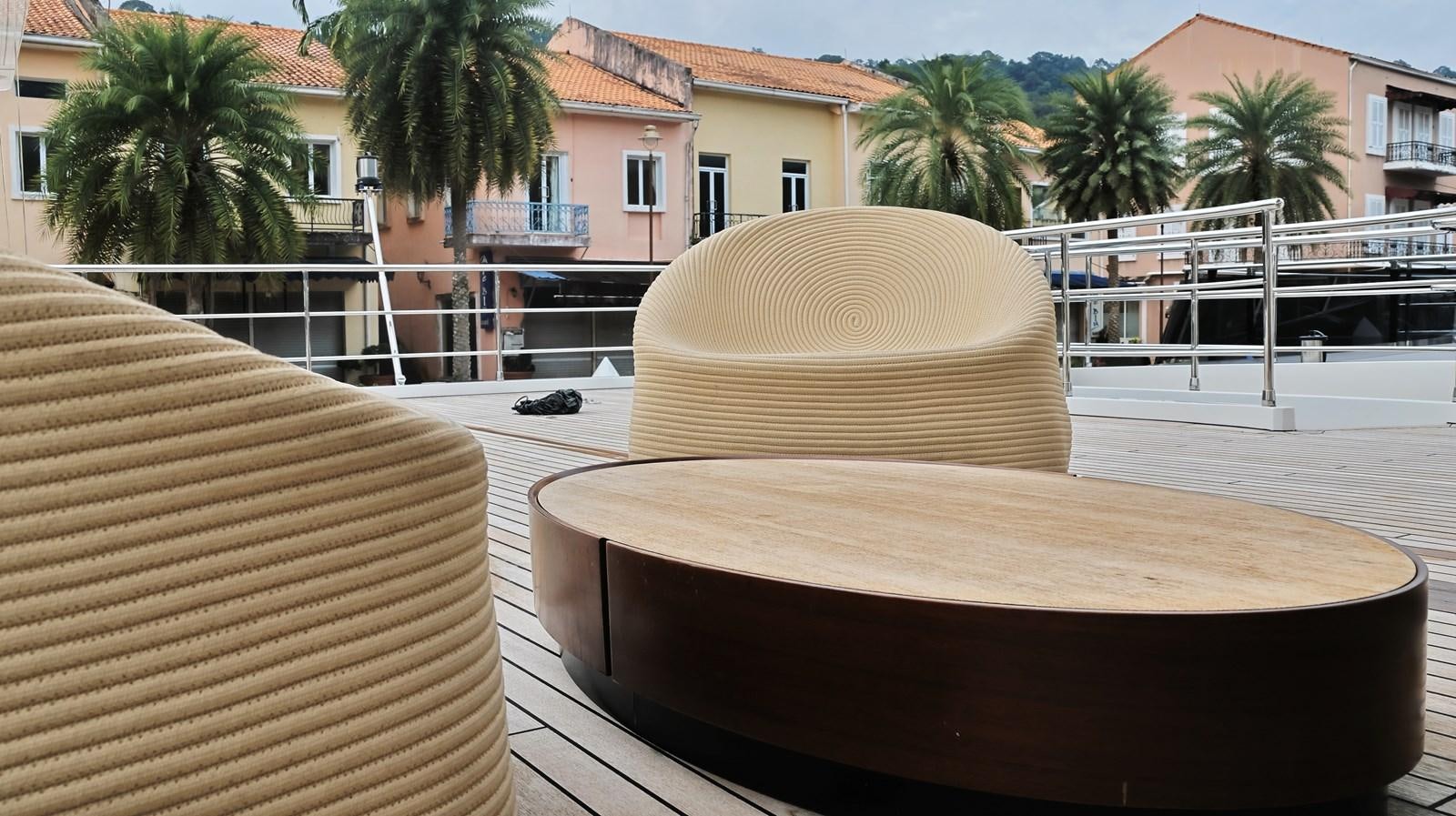 a table with a chair and a chair on it aboard M32 025 Yacht for Sale