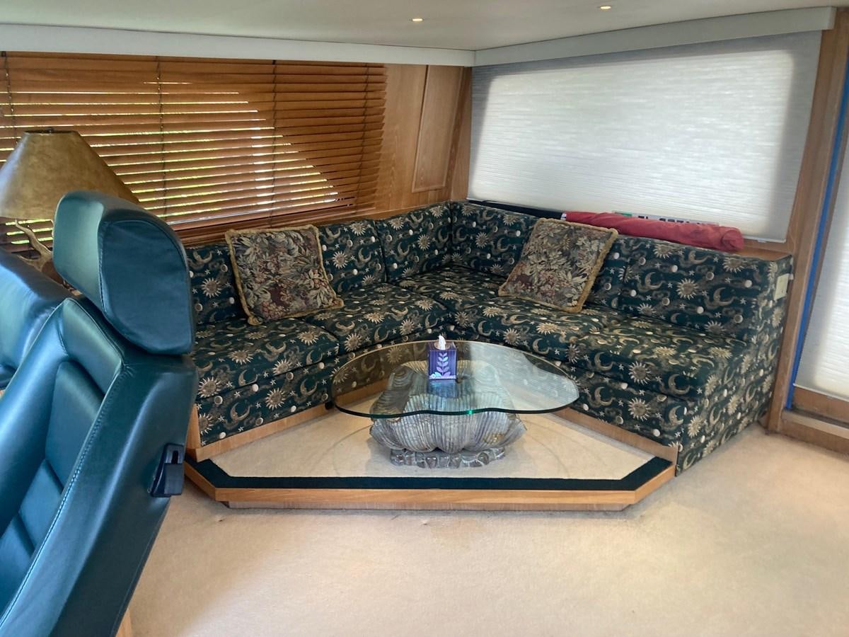 a couch with a blue chair and a round table with a blue chair aboard LADY JANE Yacht for Sale