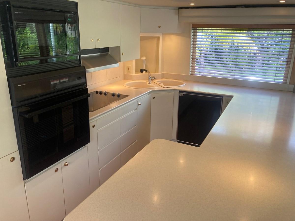 a kitchen with white cabinets aboard LADY JANE Yacht for Sale