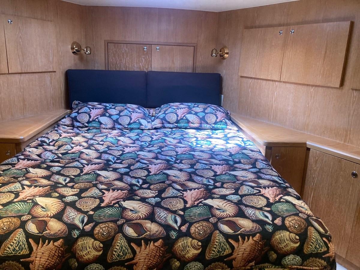 a bed with many different objects on it aboard LADY JANE Yacht for Sale